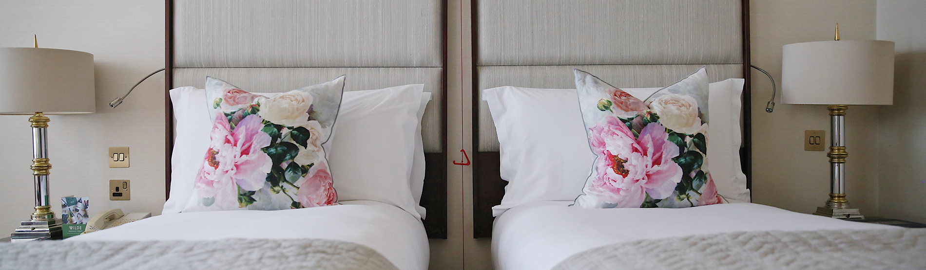 Two twin beds in a brightly lit, classic twin style room at the Westbury Hotel.