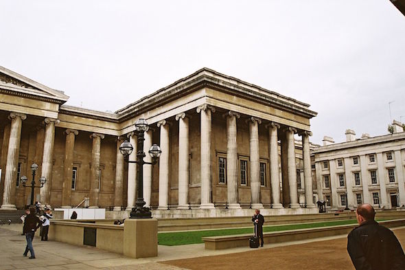 landscape picture of the exterior of the British museum front entrance with pillars during daytime including public 