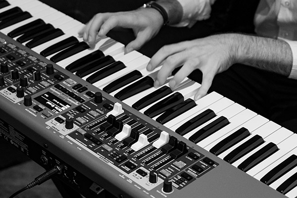 A captivating live jazz performance featuring a man singing and playing the piano at the 108 Jazz Brunch at the Marylebone Hotel