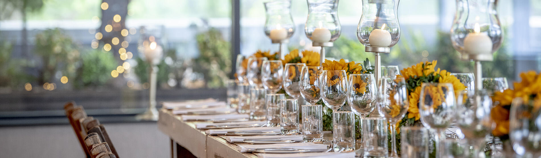 Long table with dinner setting and flowers